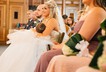 Bride breastfeeds baby during wedding ceremony photos