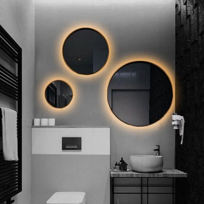 Arrangement of round bathroom wall mirrors with le